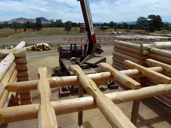 The Log wall being completed at our Log yard with the Log Floor Beams and Joist in place